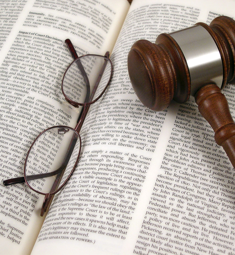 Glasses and Gavel on Open Book